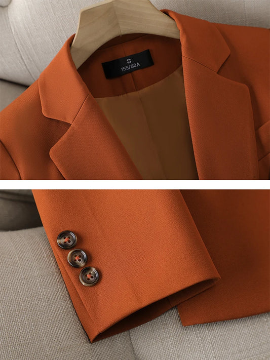 Brown blazer with brand label on a neutral background