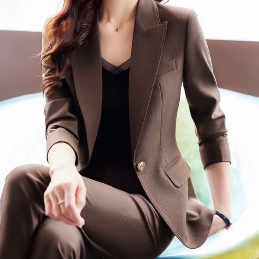 Person wearing a brown suit sitting on a blurred background
